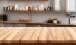 © wesleyyaya - Wooden counter with blurred kitchen background. Table in the foreground for displaying products.