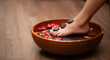 © pakorn - Woman soaks her feet in a bowl with flower petals