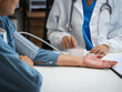 © Phushutter - Mature chinese woman in consultation with a doctor with abdominal pain. depression.