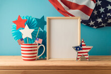 Happy Independence Day, 4th Of July Celebration Concept With Mock Up Frame And Decorations On Wooden Table Over USA Flag Background