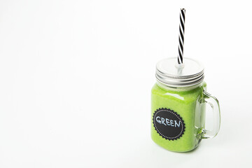 Wall Mural - Healthy green smoothie  in a jar mug  on white background