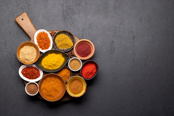 Canvas Print - Various spices in bowls on stone table