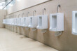 New row of outdoor urinals men public toilet