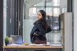 © David - Portrait of tired young business Asian woman work with documents tax laptop computer in office. Sad, unhappy, Worried, Depression, or employee life stress concept