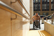 Young man with disability using ramp to move up the building