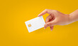 Woman Hand holding  blank credit chip card on Yellow background for business and finance