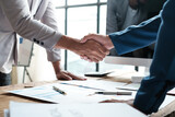 Fototapeta  - Handshake as successful negotiation ending, close-up. Unknown business people shaking hands after contract signing in modern office