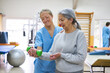 © Robert Kneschke - Nurse assisting senior woman exercising with dumbbell