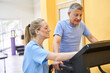 © Robert Kneschke - Young physiotherapist assisting senior man on treadmill