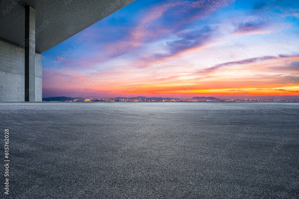 Asphalt road and city skyline with colorful sky clouds at sunset Stock ...