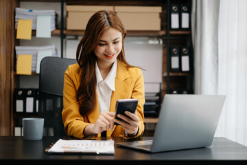 Wall Mural - Business asian woman using tablet and laptop for doing math finance on an office desk, tax, report, accounting, statistics, and analytical research concept in office