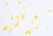 The Puddles Of An Bright Yellow Oil Paint Spill. Watercolor Yellow Drop Splash. Splatter Of Ink Drops On White Paper Background. Sample Of Cosmetics.