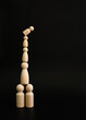 Person on stacked wooden blocks concept of balance or imbalance