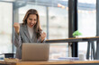 © Natee Meepian - Excited business woman surprise looking on laptop having a good news