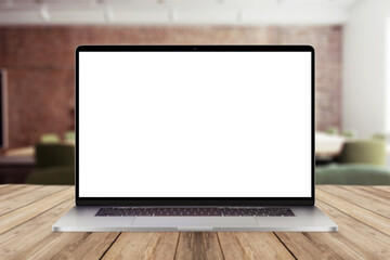 Laptop with white screen mockup display on wooden desktop with office view. Creative idea and work in office