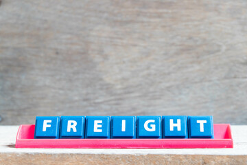 Poster - Tile alphabet letter with word freight in red color rack on wood background