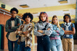 © Drazen - Multiracial group of high school students stand with their arms crossed and looking at camera.