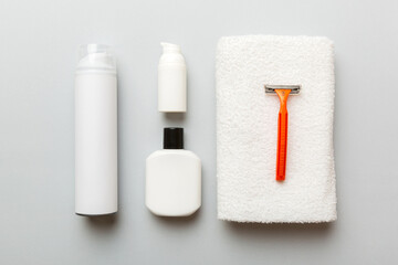 shaving man set. shaving machine, towel, lotion and shaving foam on colored background. Men bath Accessories top view