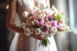The bride holds a beautiful wedding bouquet of pink and white flowers in her hands