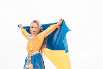 Girl in traditional ukrainian wreath on head blue and yellow flag of Ukraine in field. Ukraine's Independence Flag Day. Constitution day. 24 August. Patriotic holiday.