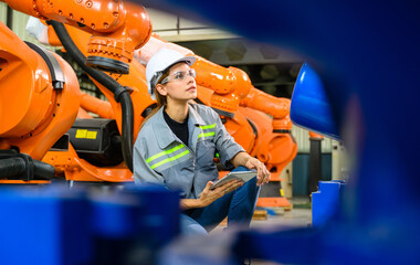 Wall Mural - Female engineer worker working with robotic machine automation