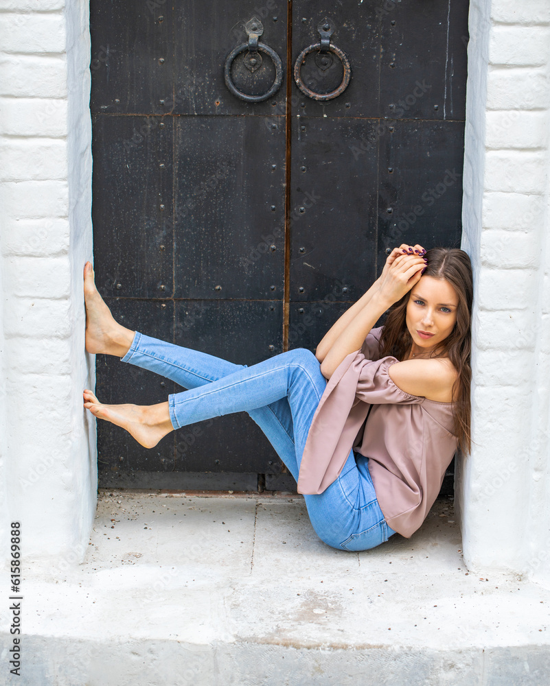 Portrait of a young beautiful brunette woman in blue jeans Stock Photo ...
