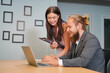 © FotoArtist - Young office worker presenting new financial plan to his partners during a meeting