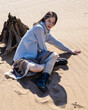 Traveler young woman is standing on the sand. Without water, sea or river