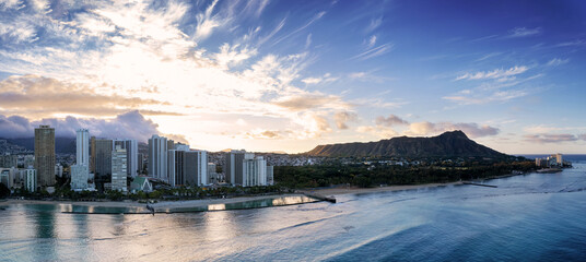 Sunrise panoramic view of the densest parts of Honolulu at Waikiki and its beach and hotels and Diamond Head