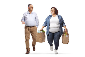 Wall Mural - Overweight woman carrying grocery bags walking and talking to a mature man