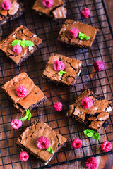 Wall Mural - Brownie squares decorated with fresh raspberry and mint leaves