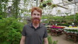 © Marco - Happy Customer Portrait, Caucasian Redhead Male in 30s, Standing Inside Flower Shop - Looking at Camera in Horticulture Place