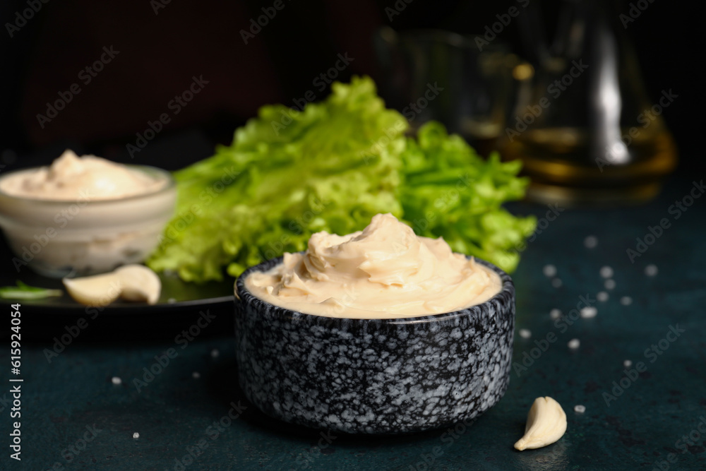 Bowl of tasty cream cheese on dark background