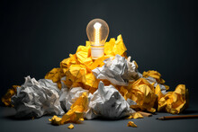 Piles Of Crumpled Paper Around A Light Bulb Shining With A Idea.