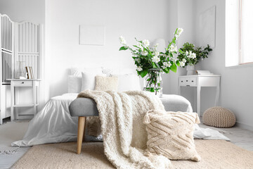 Poster - Vase with blooming jasmine flowers on bedside bench in interior of light bedroom