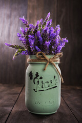 Sticker - bundle of lavender flowers in retro vase isolated on an old wooden background