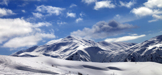 Poster - Panoramic view on ski slope and beautiful sky with clouds in sunny evening. Tetnuldi, Caucasus Mountains, Svaneti region of Georgia.