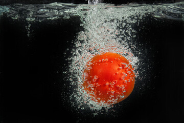 Wall Mural - Tomato in the water on isolated studio background