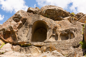 Wall Mural - Horse relief and niche carved on steep rock located near Fasillar village, Konya, Turkey. Atlikaya - Rock of Horsman.