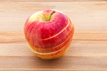 Wall Mural - Red apple close-ups cut by mugs on a cutting board