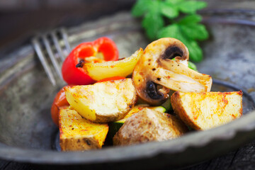 Wall Mural - Vegetarian cooking. Organic roasted baked vegetables in vintage setting. Potatoes, paprika, mushrooms, onion, zucchini and herbs