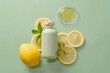 Template cosmetic mockup with green bottle unbranded with lemon slices, green leave and petri dish decorated on pastel background. Lemon has many good uses for health and beauty