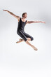 © danmorgan12 - Ballet Dancer Young Caucasian Athletic Man in Black Suit Dancing in Studio Over White Background With Lifted Hands.