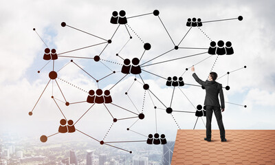 businessman on house roof presenting networking and connection concept. mixed media