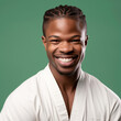 © Leaf - a smiling young men wearing karate clothes in dark green sage background generative ai