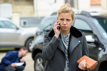 woman using her phone with car problem