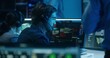 © Framestock - Diverse flight control operators in headsets monitor space mission on computers in mission control center. Team clap hands after successful space rocket launch displayed on big digital screens.