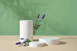 Fresh lavender flowers displayed with a set of three podiums. Podiums with empty space for organic cosmetic product advertising of Lavender (Lavandula) extract