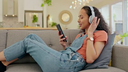 Poster - Woman, phone and headphones on sofa dancing, audio streaming and listening to audio, hip hop radio and home break. Relax, couch and young person for gen z music, electronics and mobile in living room