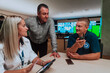 © .shock - Group of security guards sitting and having briefing In the system control room They're working in security data center surrounded by multiple Screens